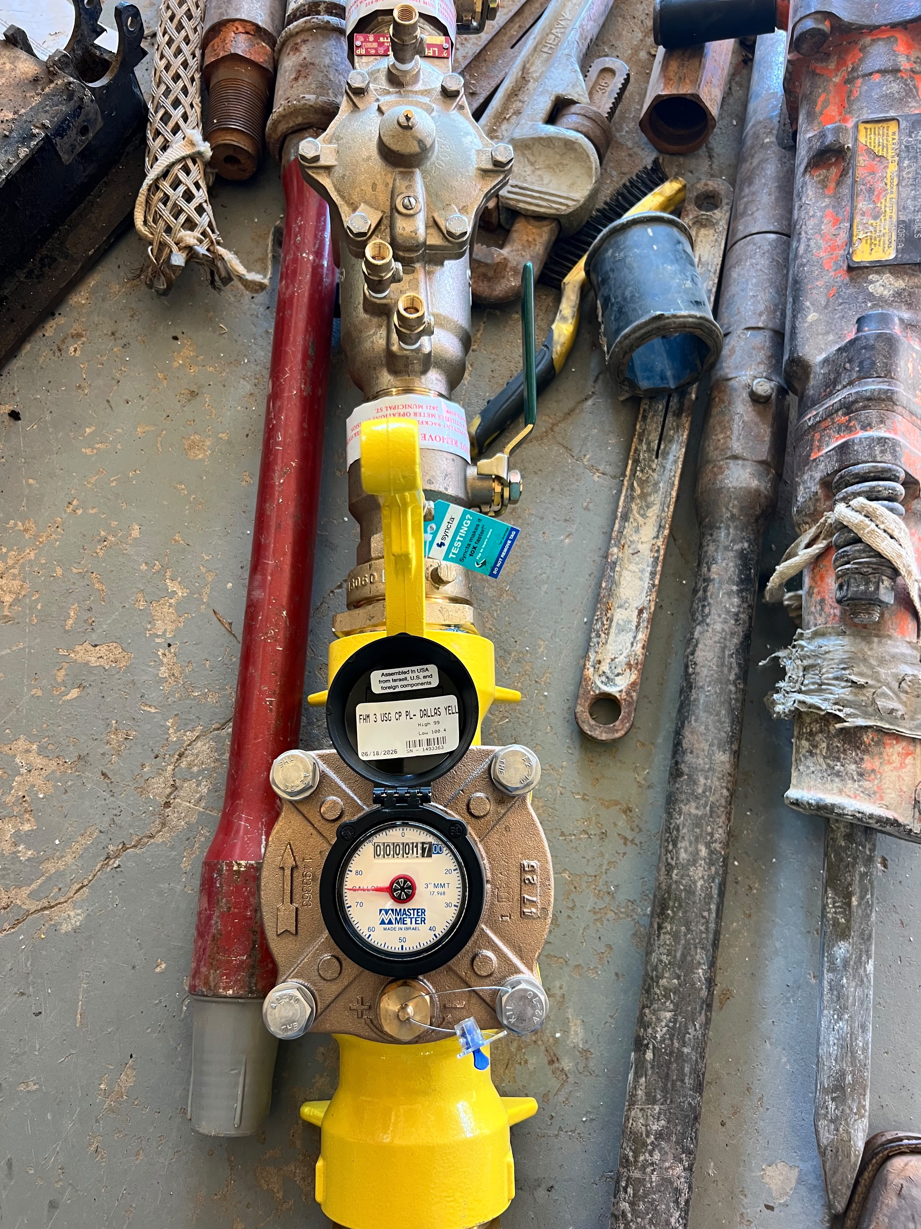 Meter assembly and boring tools laid out on a jobsite